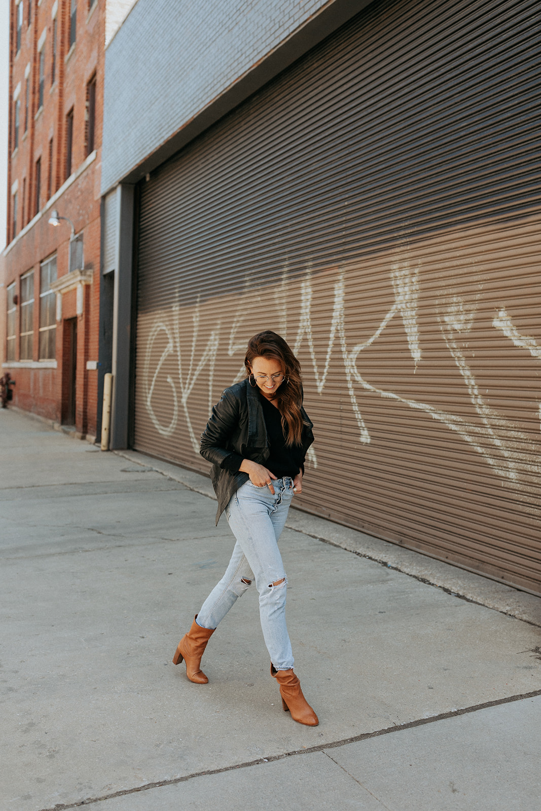 Emily Eliza Moyer in a camel coat on a city street